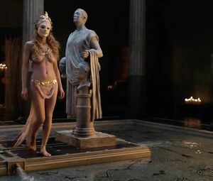 Man with golden paint on skin penetrates skinny girl in sex moment from Spartacus